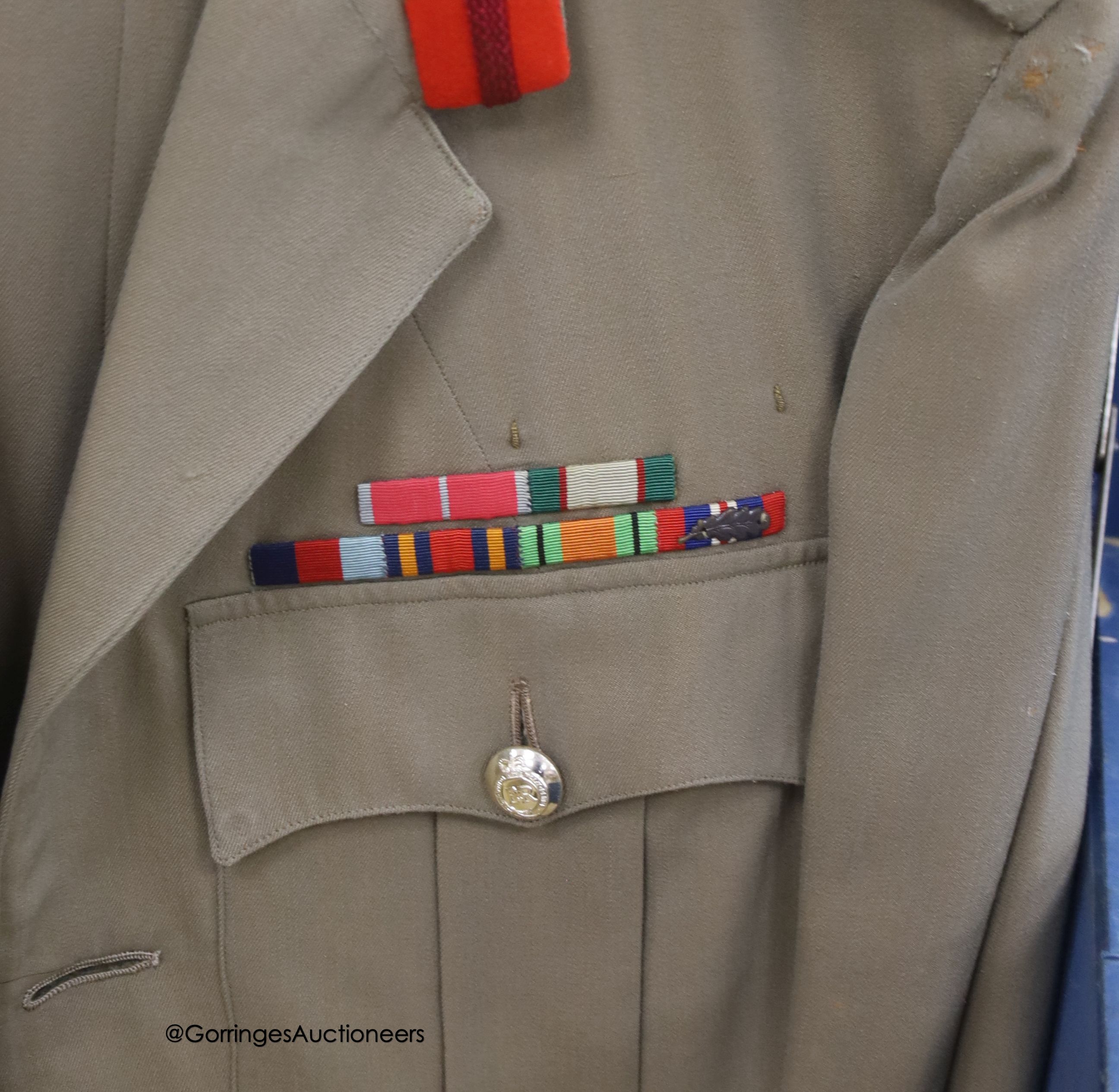 Three Khaki uniforms, one jacket without trousers, contained within a cabin trunk